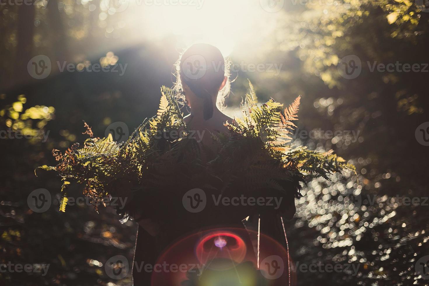 Lady holds fern leaves scenic photography photo