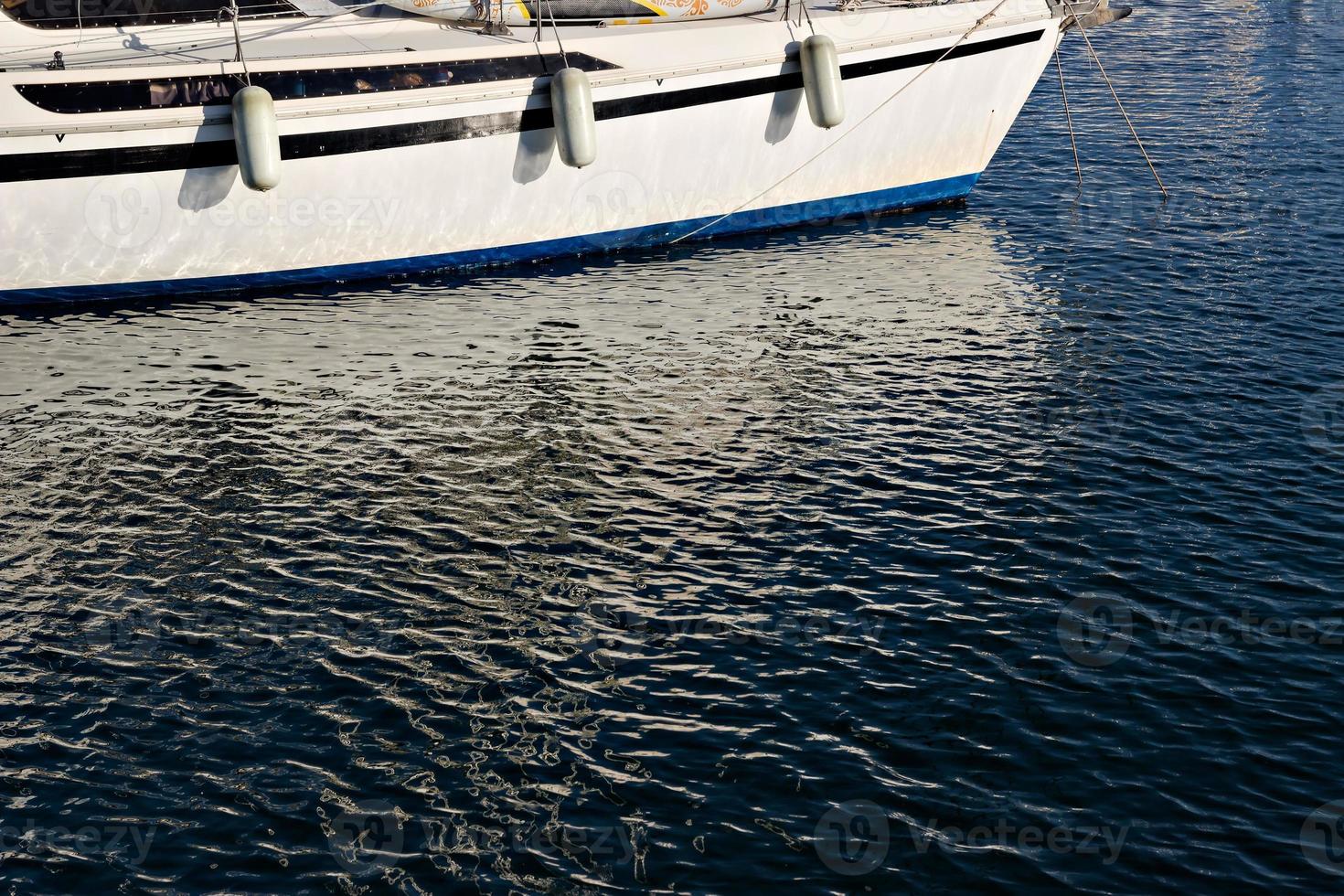 Pleasure boat with reflections in the water in the marina. Horizontal image. photo