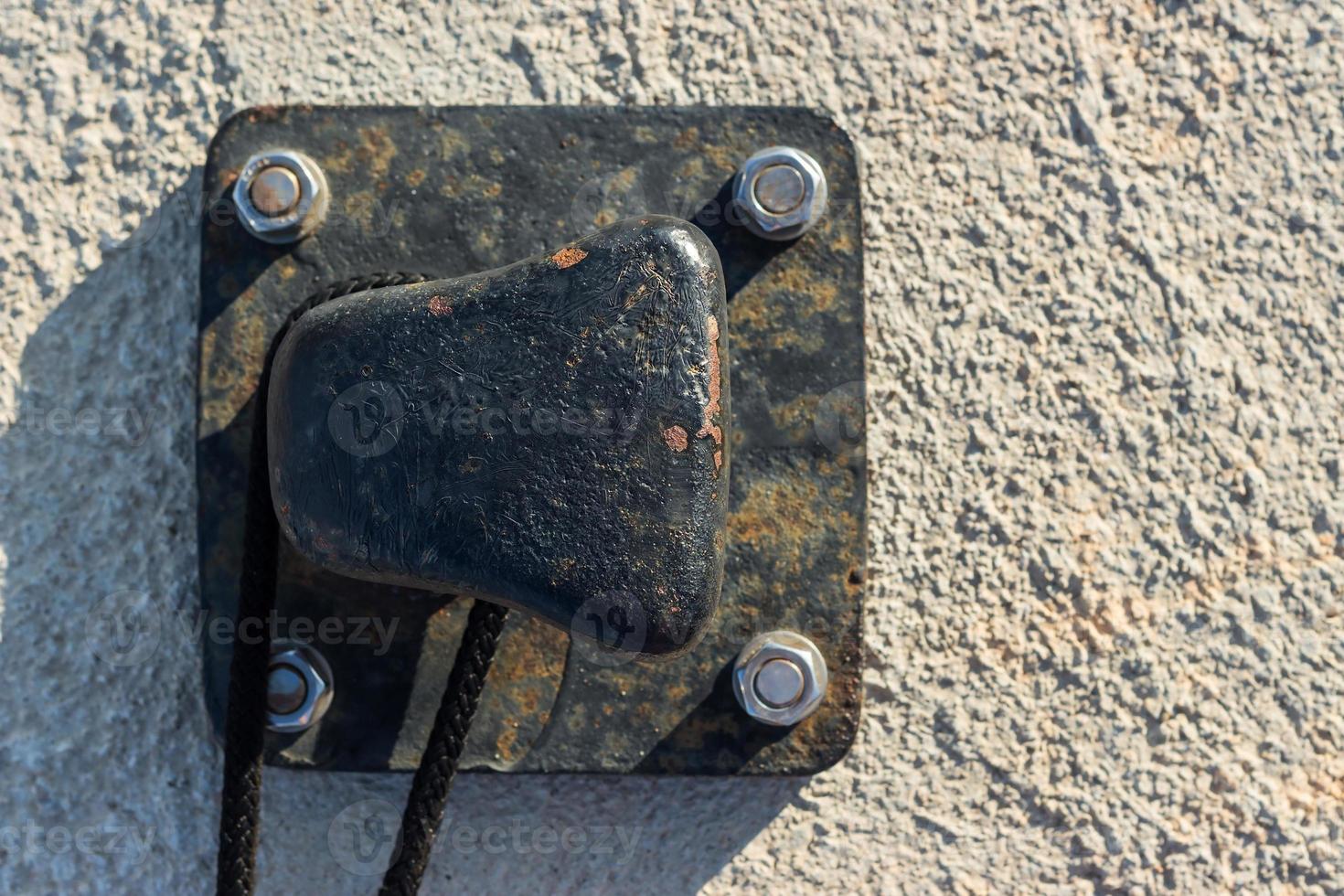 Close up iron pier with rope tied on the pier. Horizontal image. photo