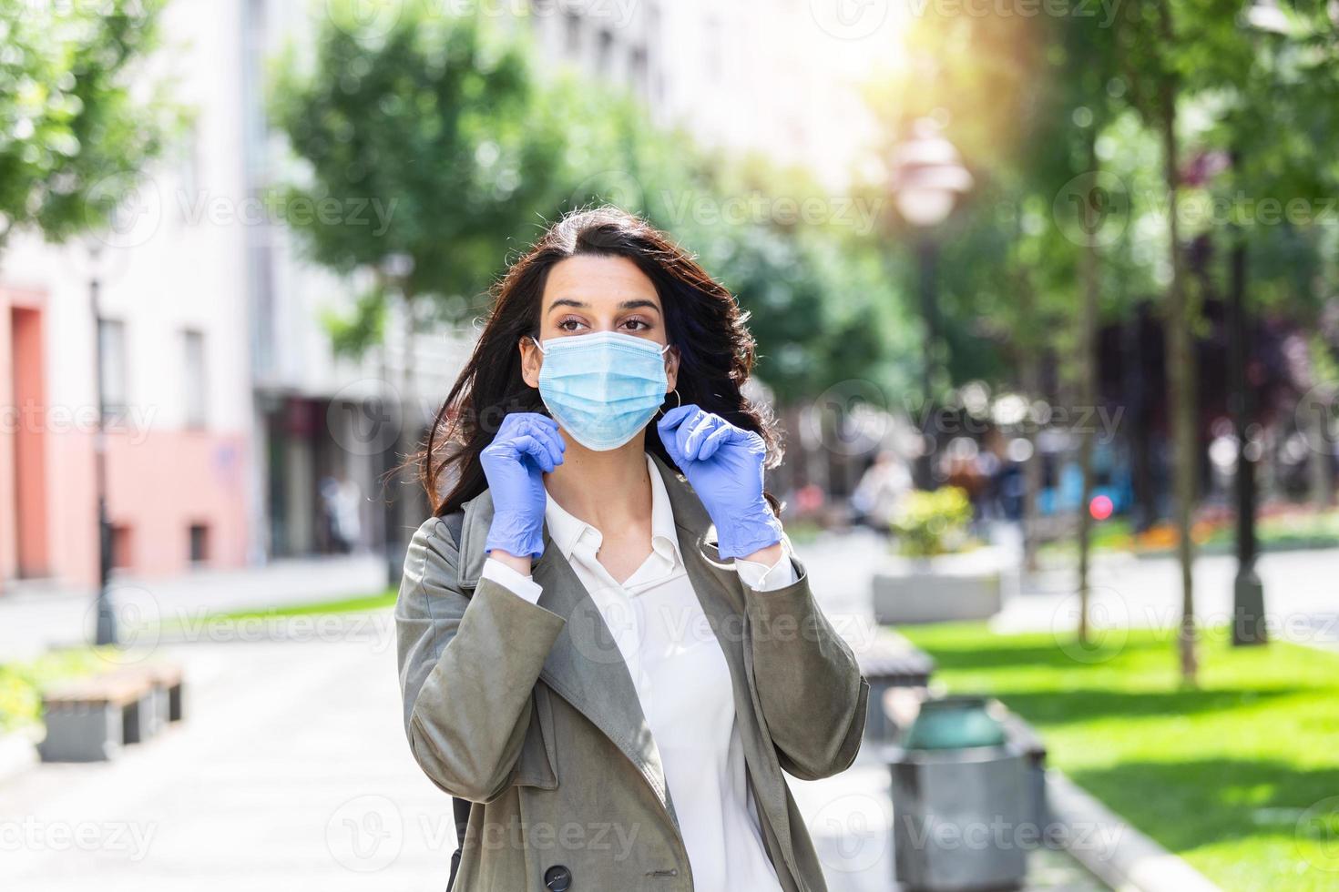 Girl in respiratory mask. Cold, flu, virus, tonsillitis, respiratory disease, quarantine, epidemic concept. Young woman on the street wearing face protective mask to prevent Coronavirus and anti-smog photo