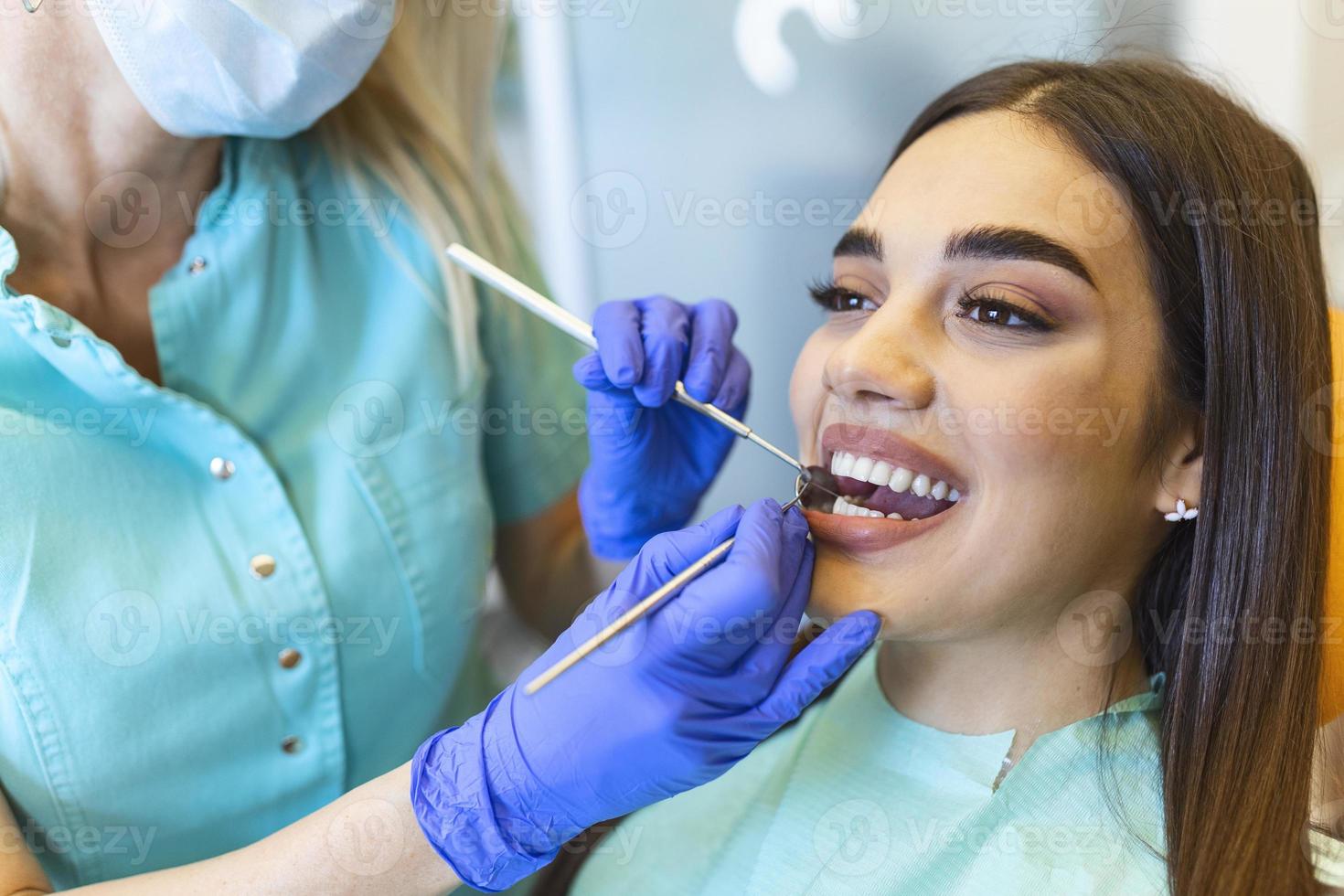 Painkiller anesthesia injection. Dentist examining a patient's teeth in modern dentistry office. Closeup cropped picture with copyspace. Doctor in disposable medical facial mask. photo