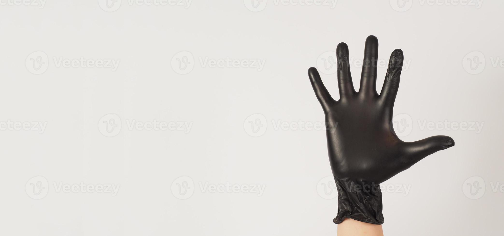 Empty Hand is wear black latex gloves on white background. 14887051