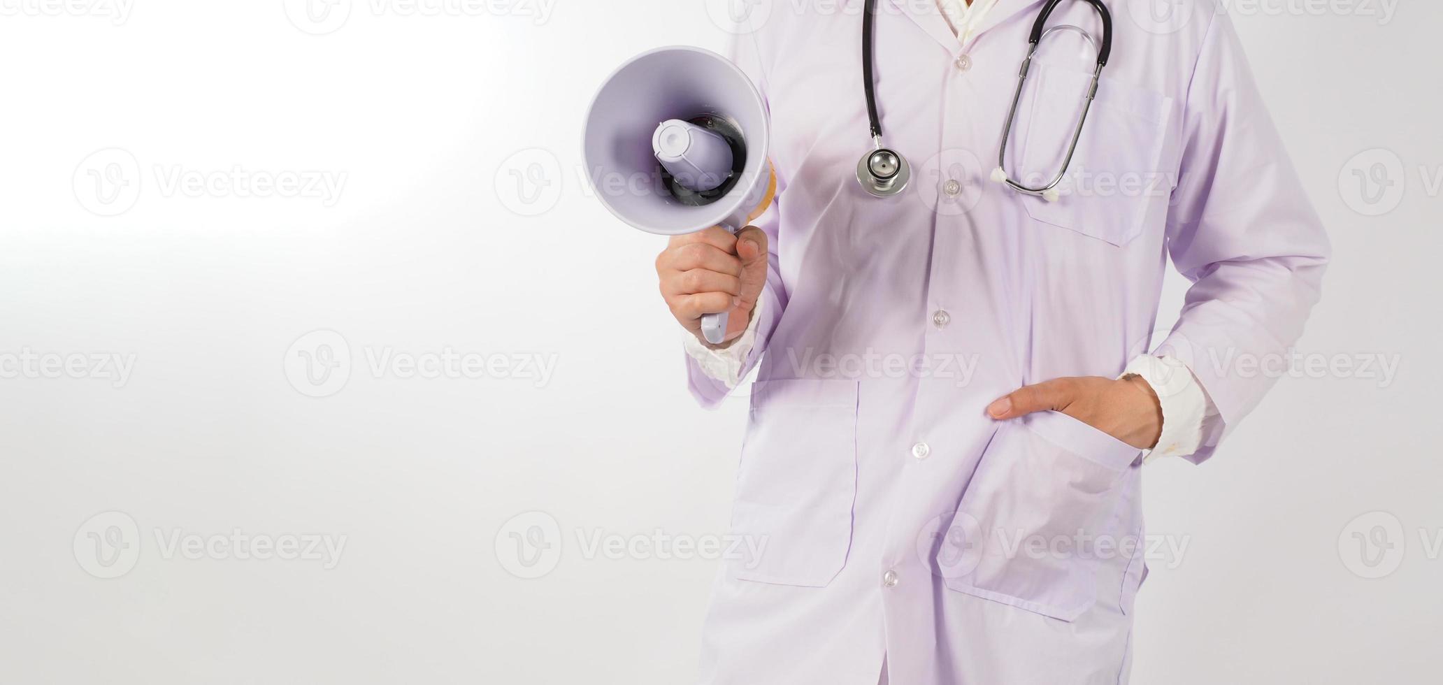 Body part of a doctor is holding megaphone on white background. photo