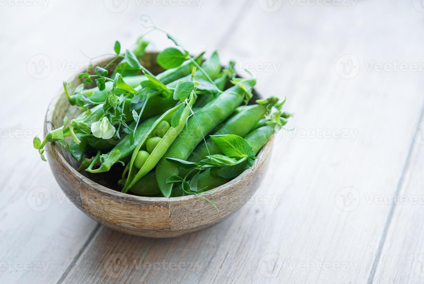 Bowl with sweet pea pods photo