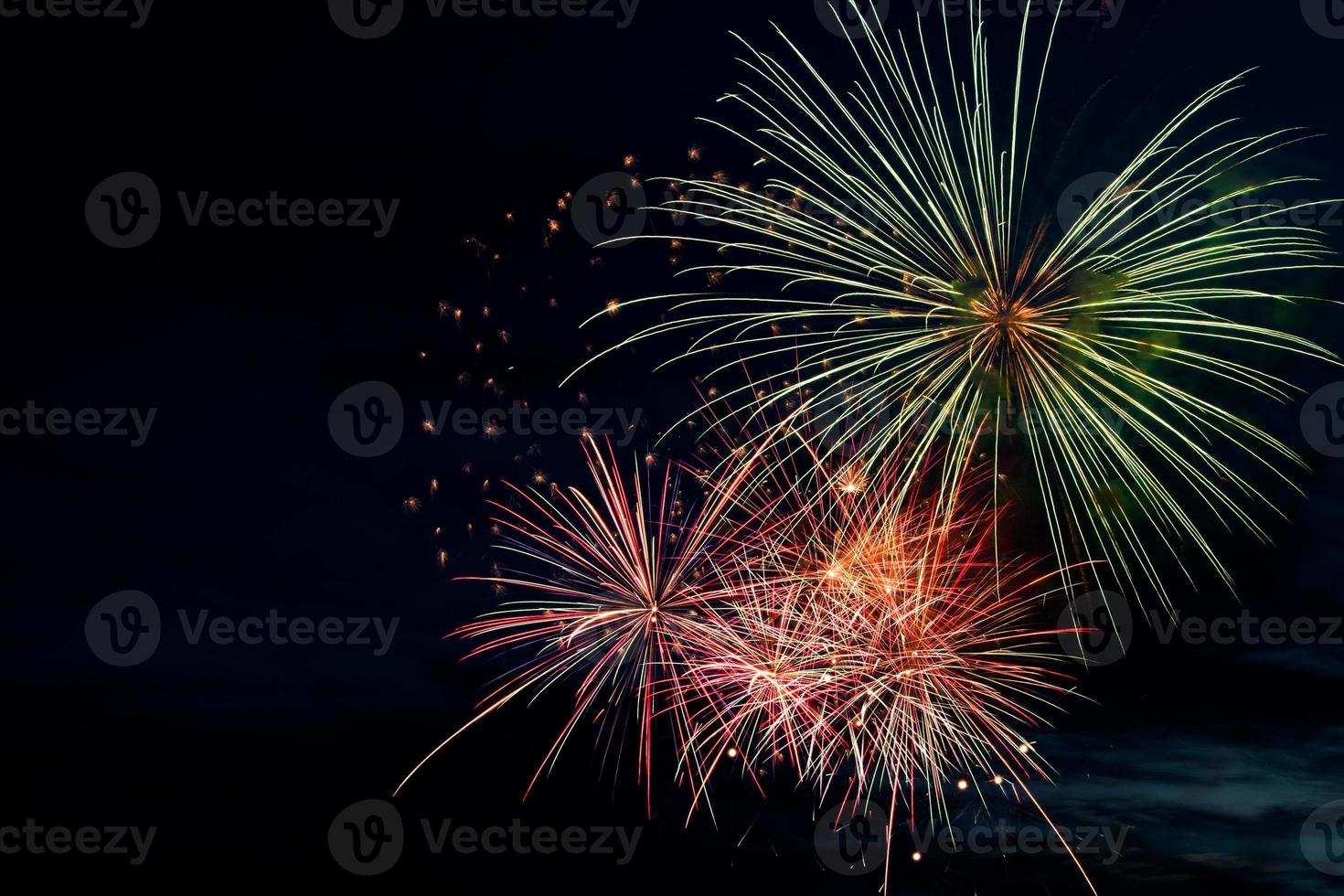 Colorful fireworks on black background. Celebration and holidays concept. Independence Day 4th of July, New Year, festival. Bright explosions of lights in sky. photo