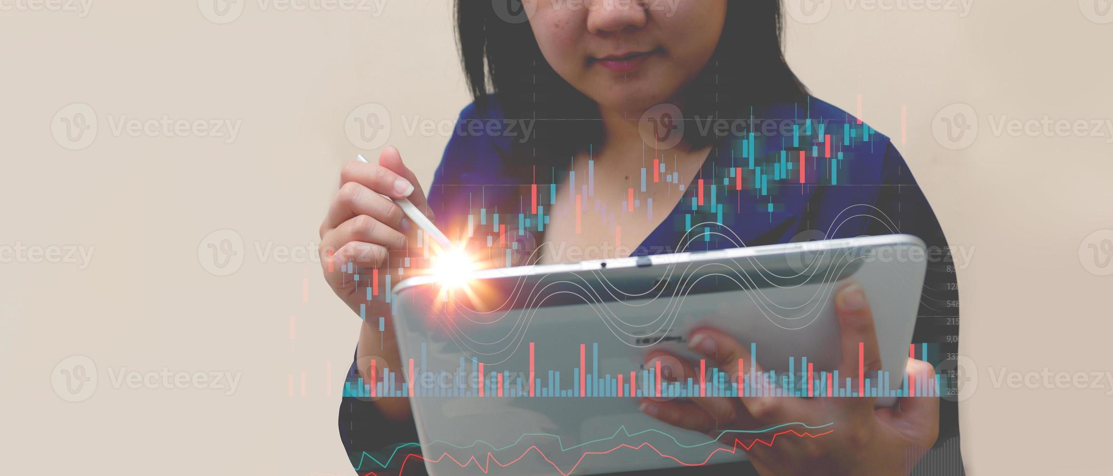 Woman draw growth graphs and progress of business and analyze financial, and investment.Use technology to plan strategy to success goals and growth.online business, e-commerce, online marketing. photo