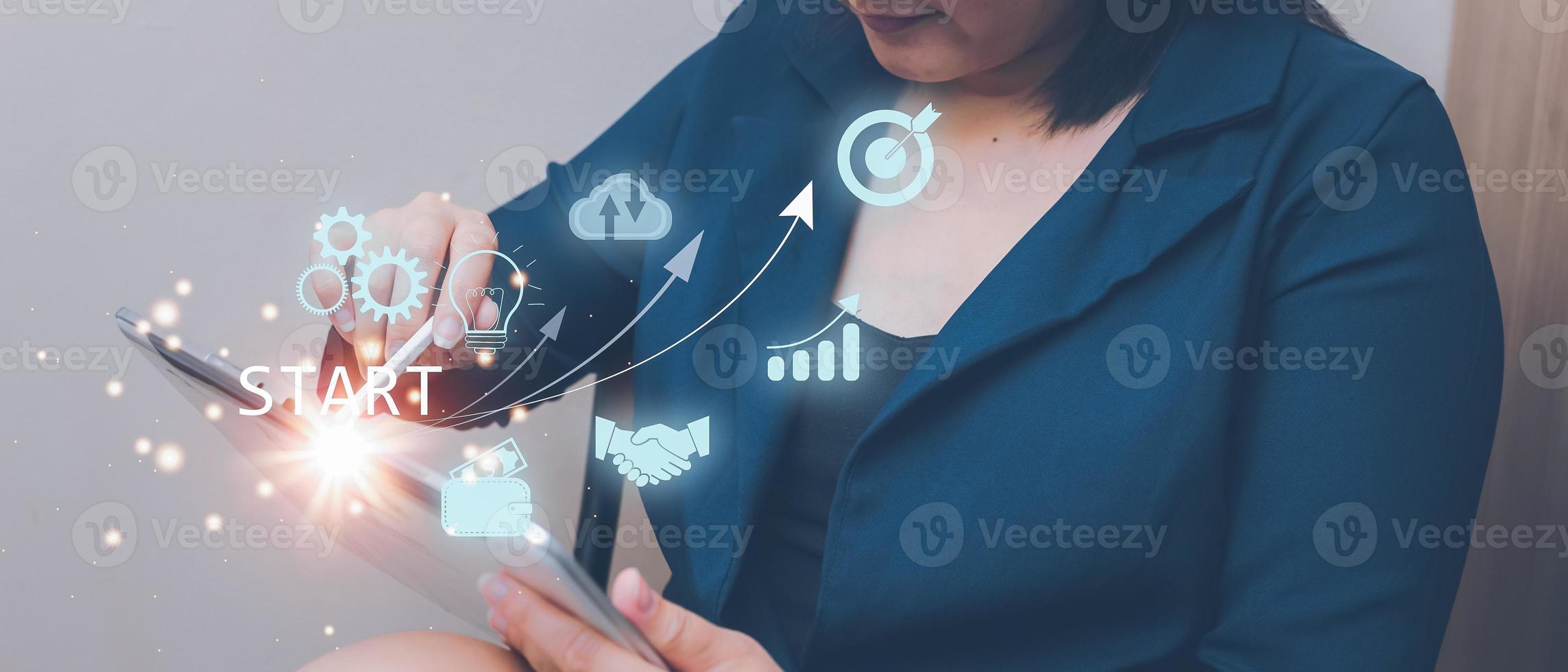 Woman touching on tablet.startup concept with icon business and network connection on modern virtual interface from digital tablet. photo