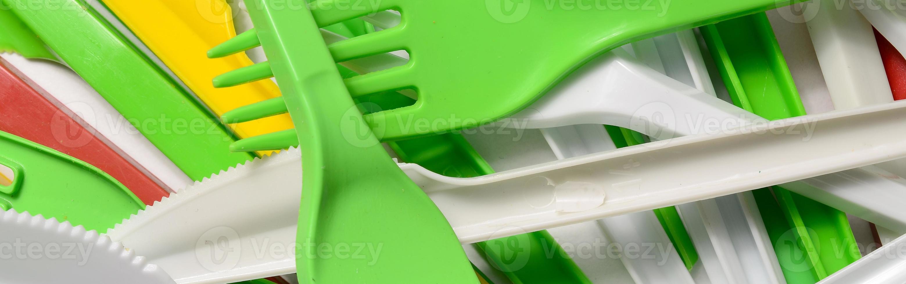 Pile of bright yellow, green and white used plastic kitchenware