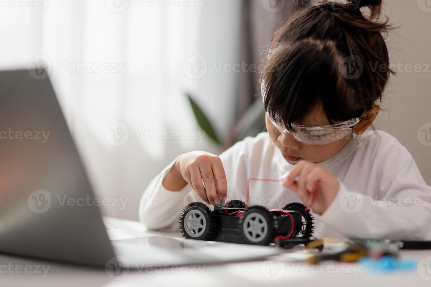 Asia students learn at home in coding robot cars and electronic board cables in STEM, STEAM, mathematics engineering science technology computer code in robotics for kids concept. photo