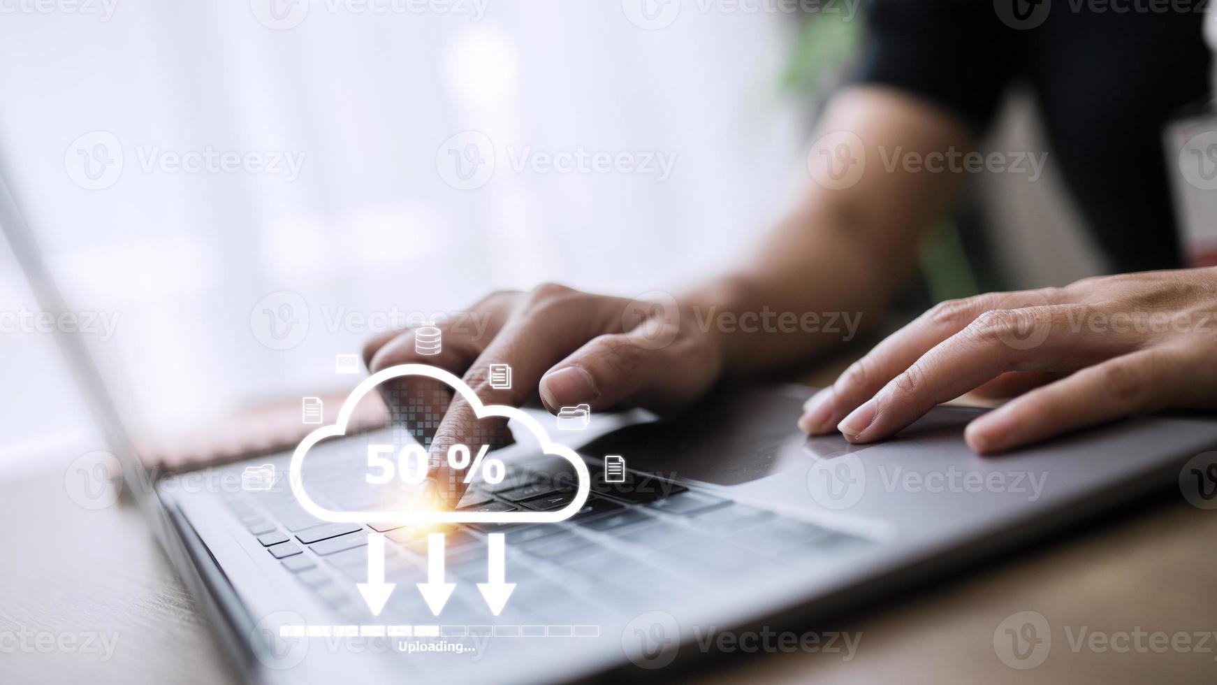 Woman doing cloud uploading on laptop in office. Data infomation photo