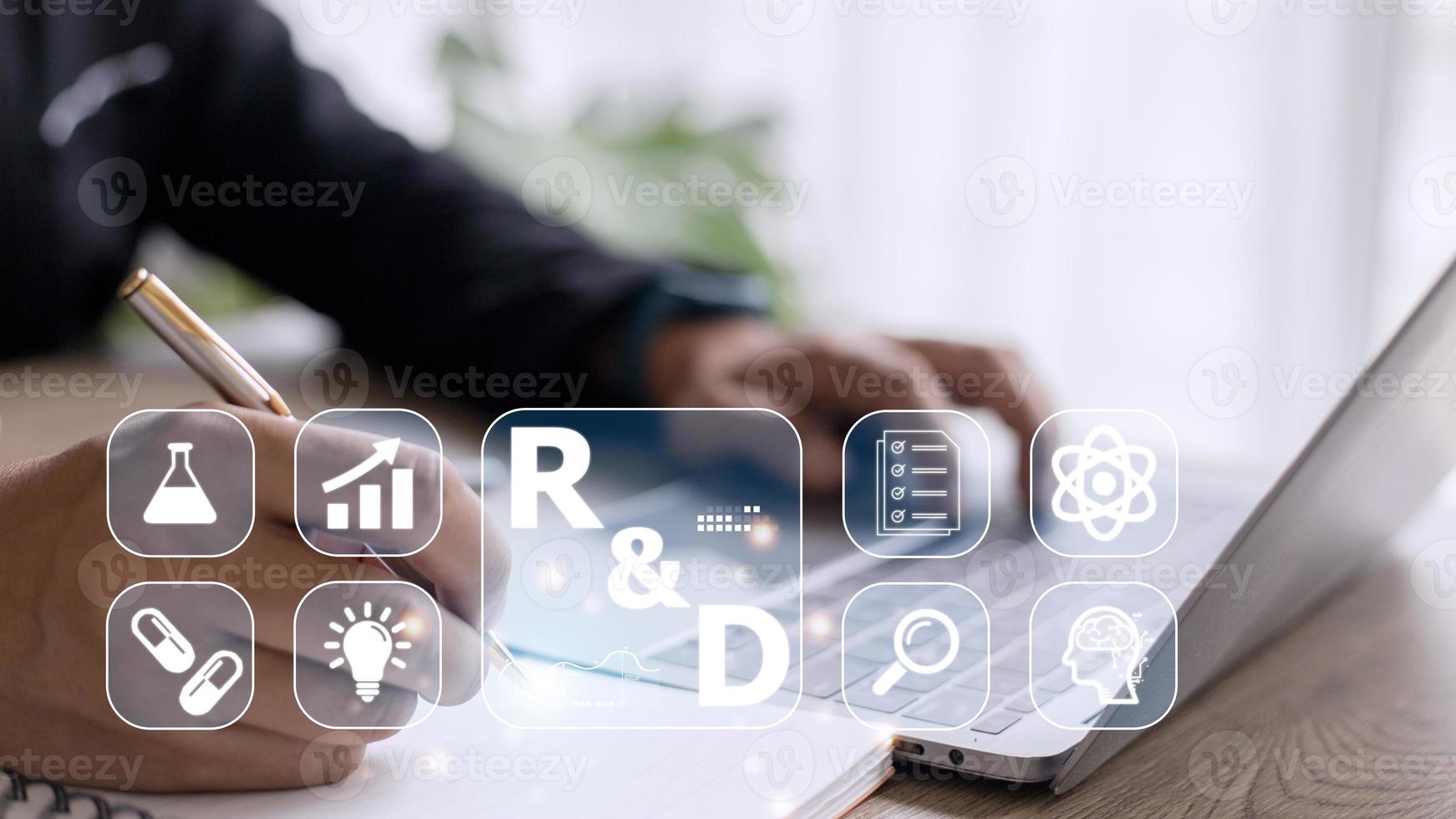 Hand of businessman holding a pen pointing to R and D icon for Research and Development on laptop screen. Manage costs more efficiently. R and D innovation concept. photo