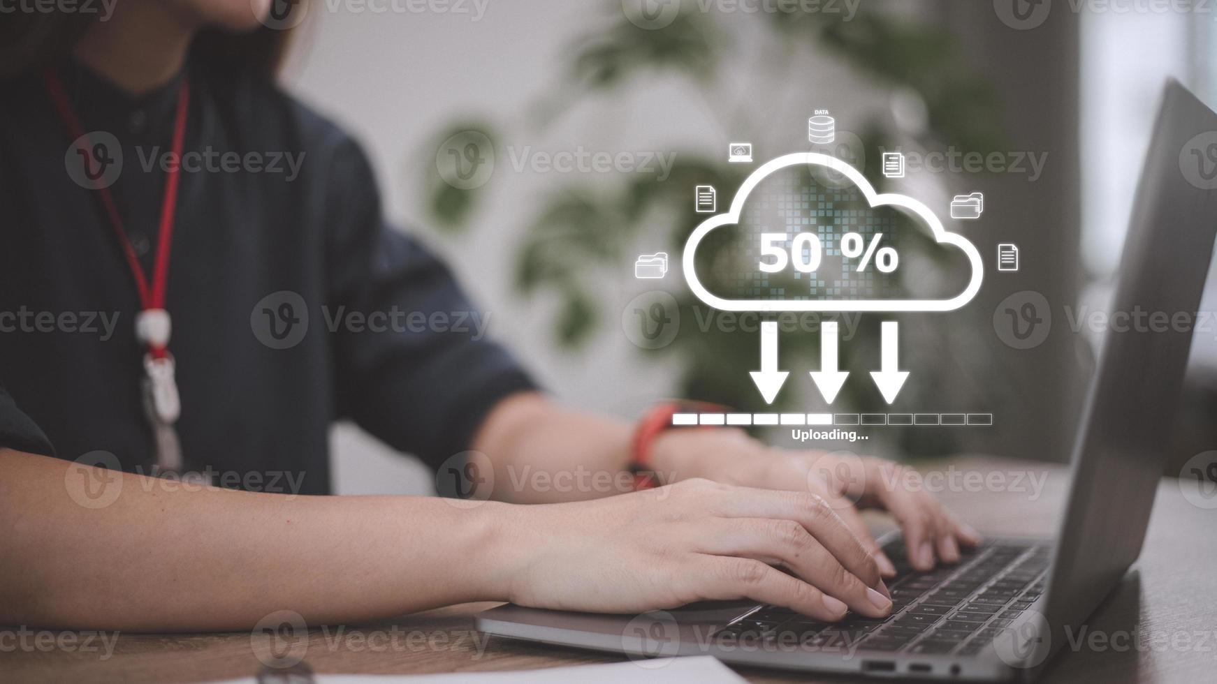 Woman doing cloud uploading on laptop in office. Data infomation photo