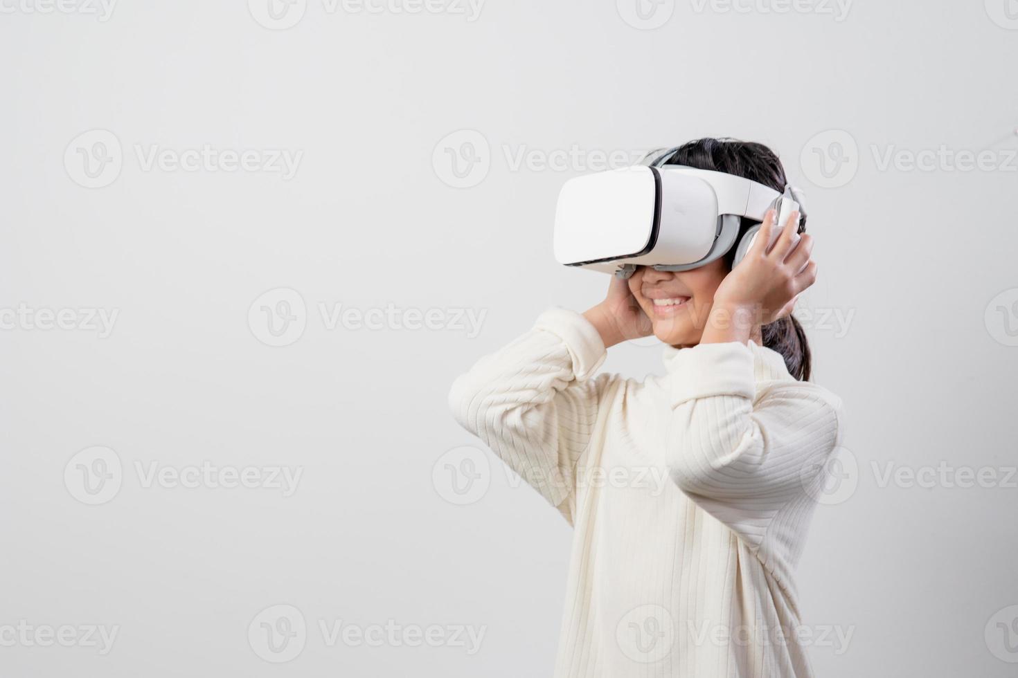 Asian little girl with virtual reality headset. Innovation technology and education concept photo