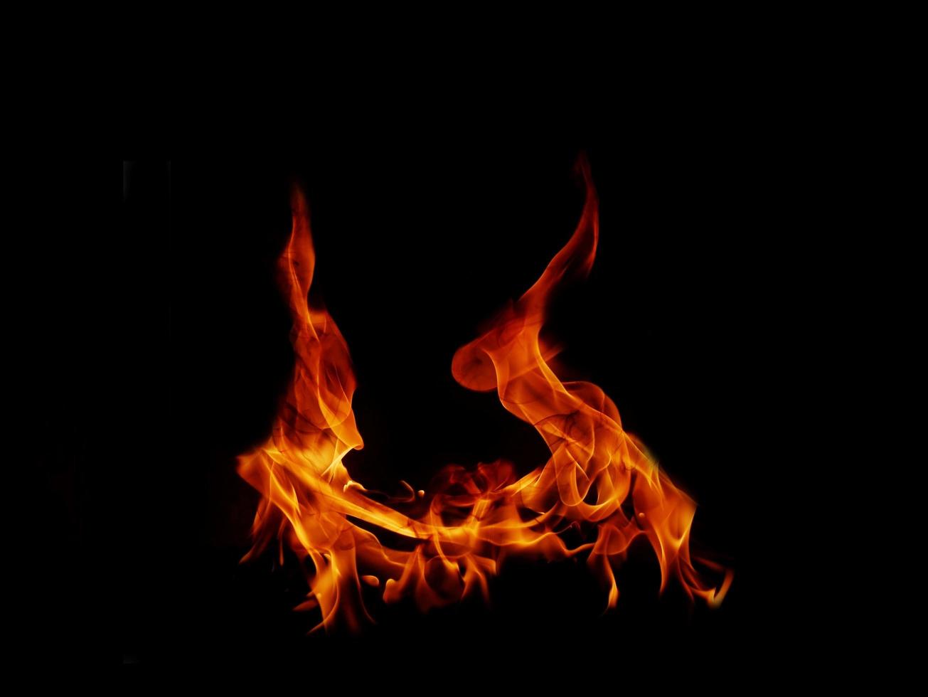 A beautiful flame shaped as imagined. like from hell, showing a dangerous and fiery fervor, black background. photo