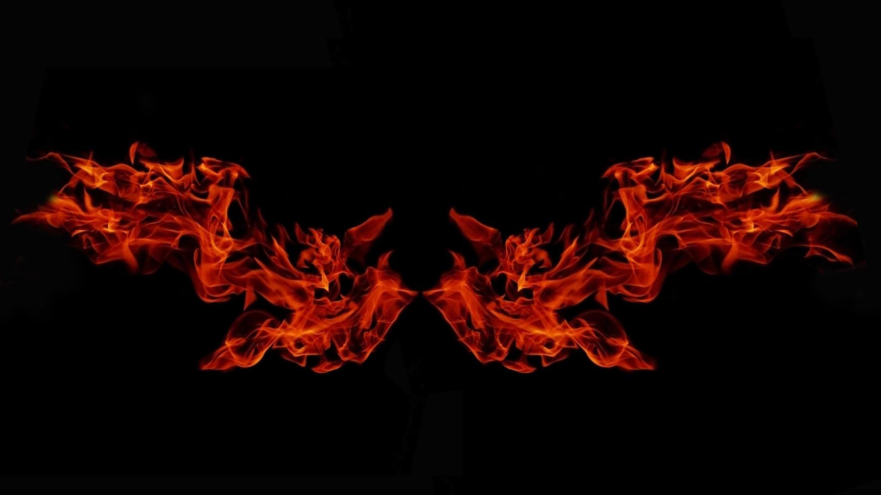 A beautiful flame shaped as imagined. like from hell, showing a dangerous and fiery fervor, black background photo