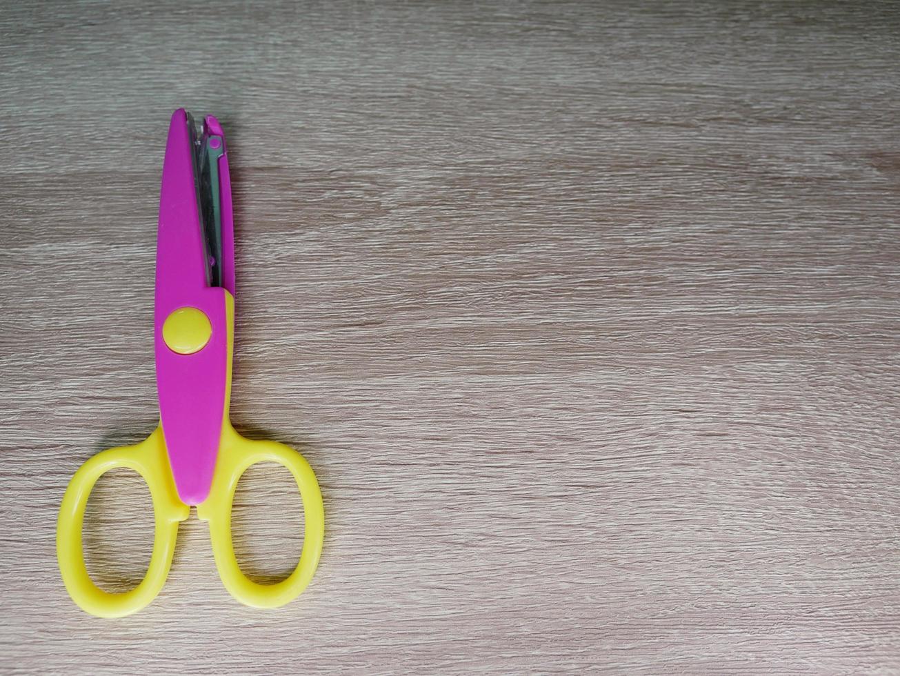 Children's wavy-patterned paper scissors to use in various inventions. photo