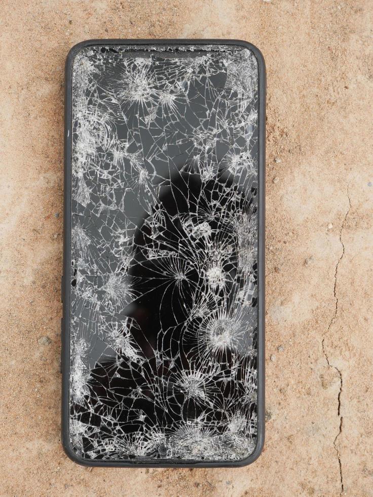 The smartphone hit the floor, it fell into a crack. photo