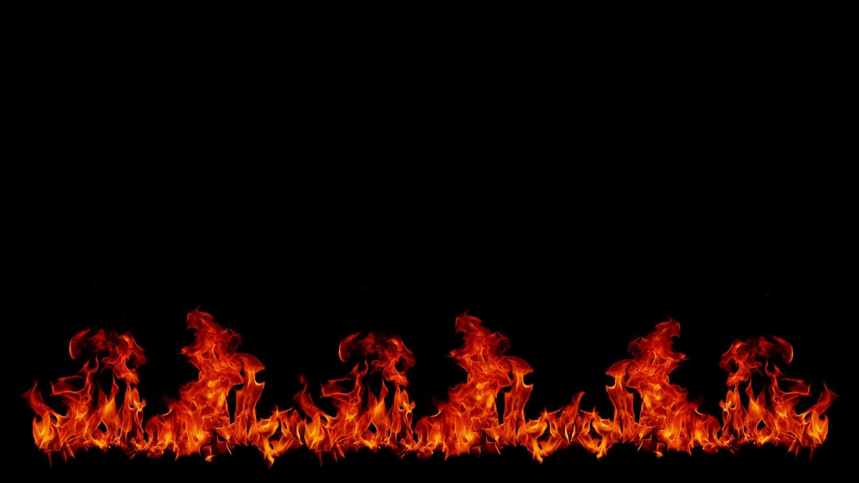 A beautiful flame shaped as imagined. like from hell, showing a dangerous and fiery fervor, black background photo