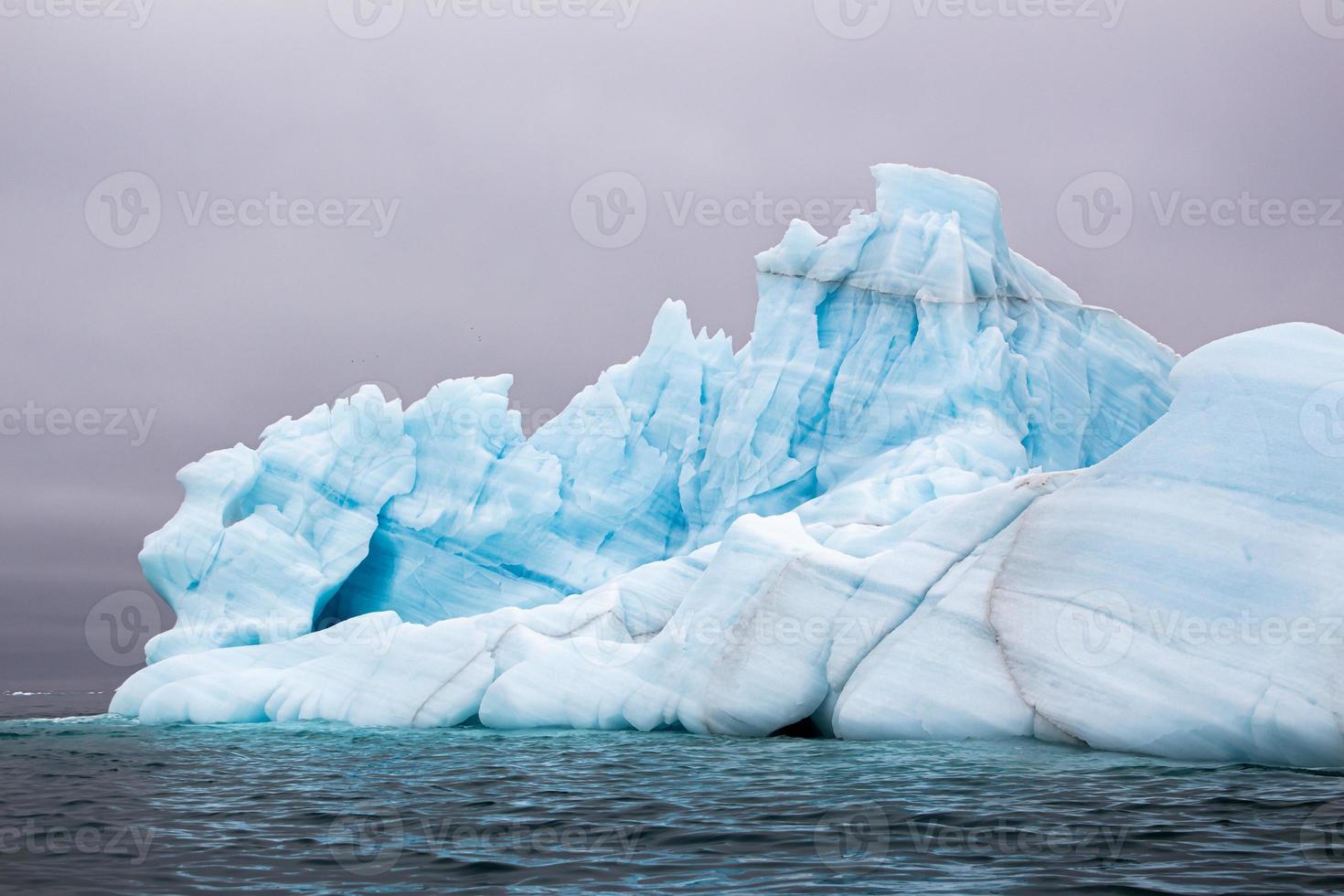 A blue Iceberg floating in the sea in Svalberg photo