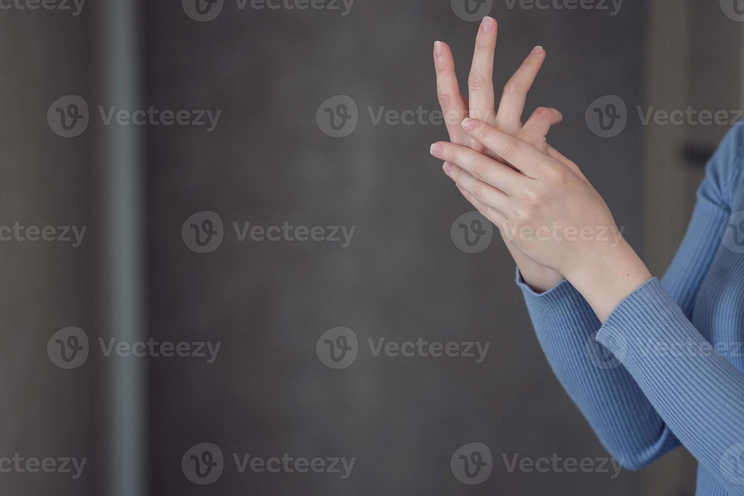 woman applying cream on hand photo