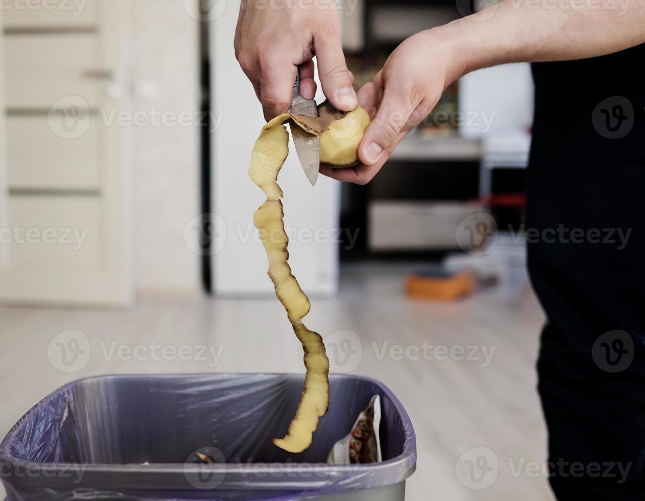 chef peeling potatoes photo