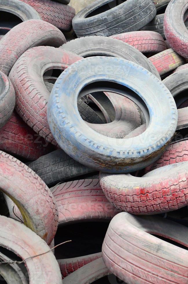 A picture of many old used tires left on a waste dump photo