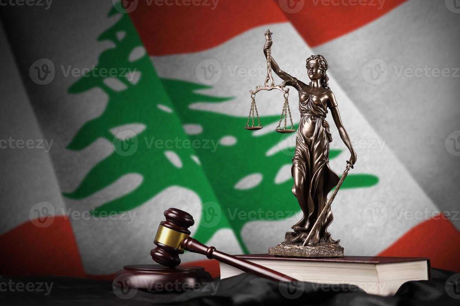 Lebanon flag with statue of lady justice, constitution and judge hammer on black drapery. Concept of judgement and guilt photo