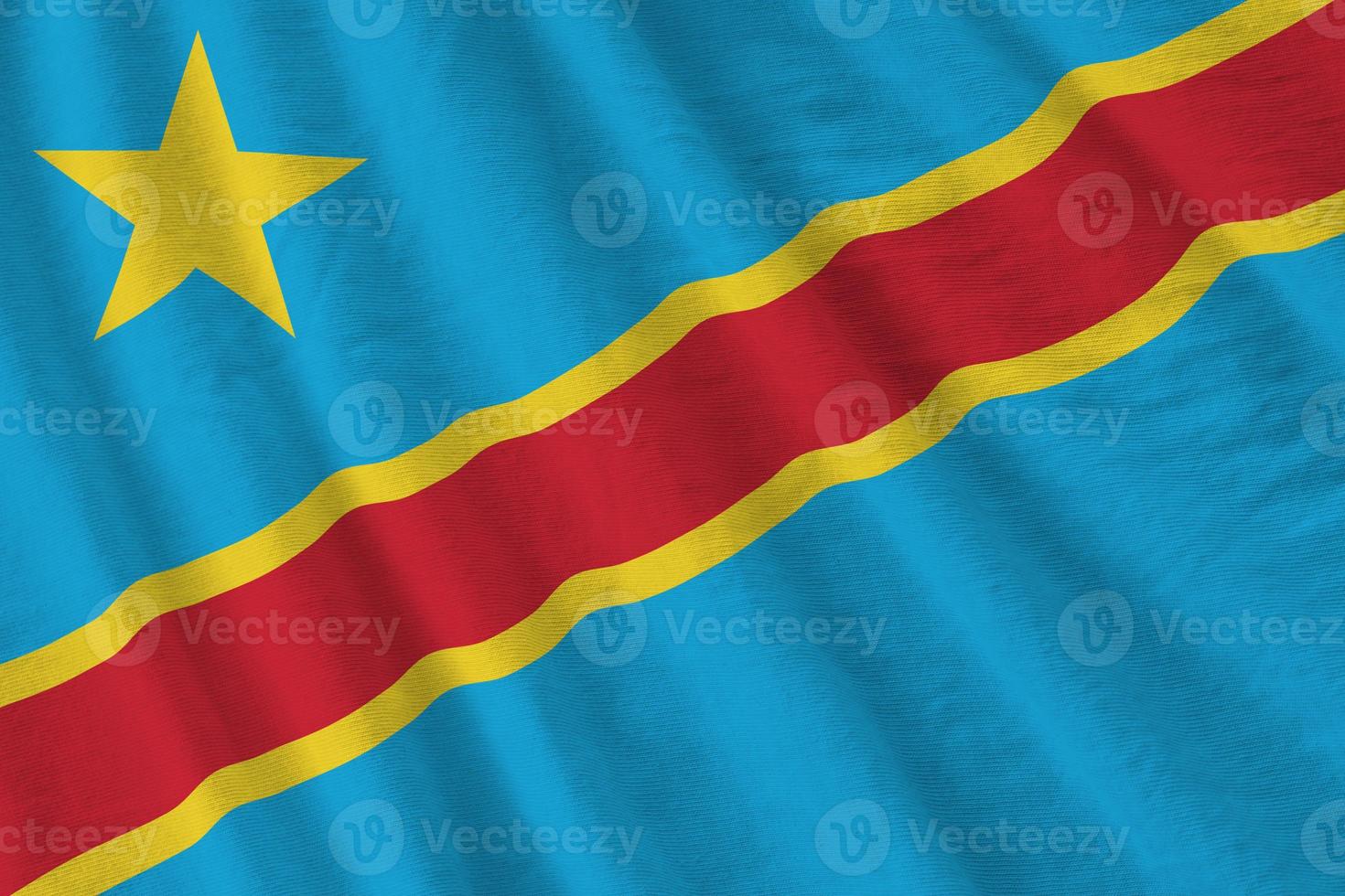 Democratic Republic of the Congo flag with big folds waving close up under the studio light indoors. The official symbols and colors in banner photo