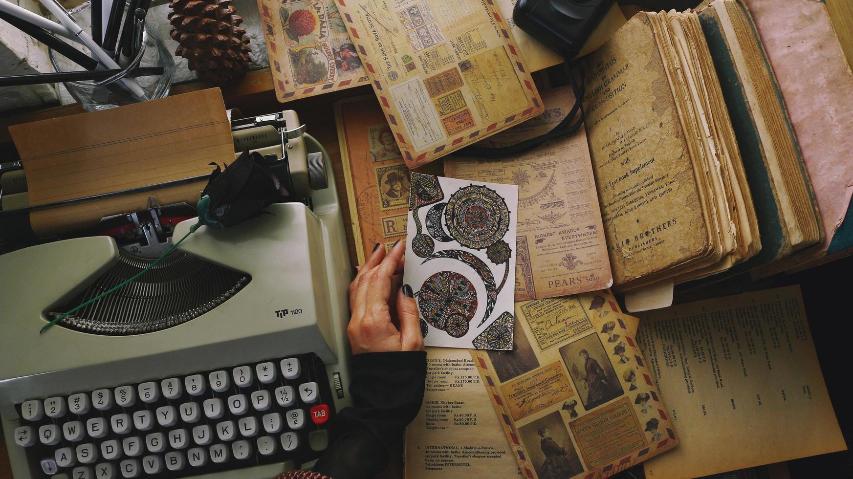 Vintage Desk Top Setting With Old Books And Typewriter photo