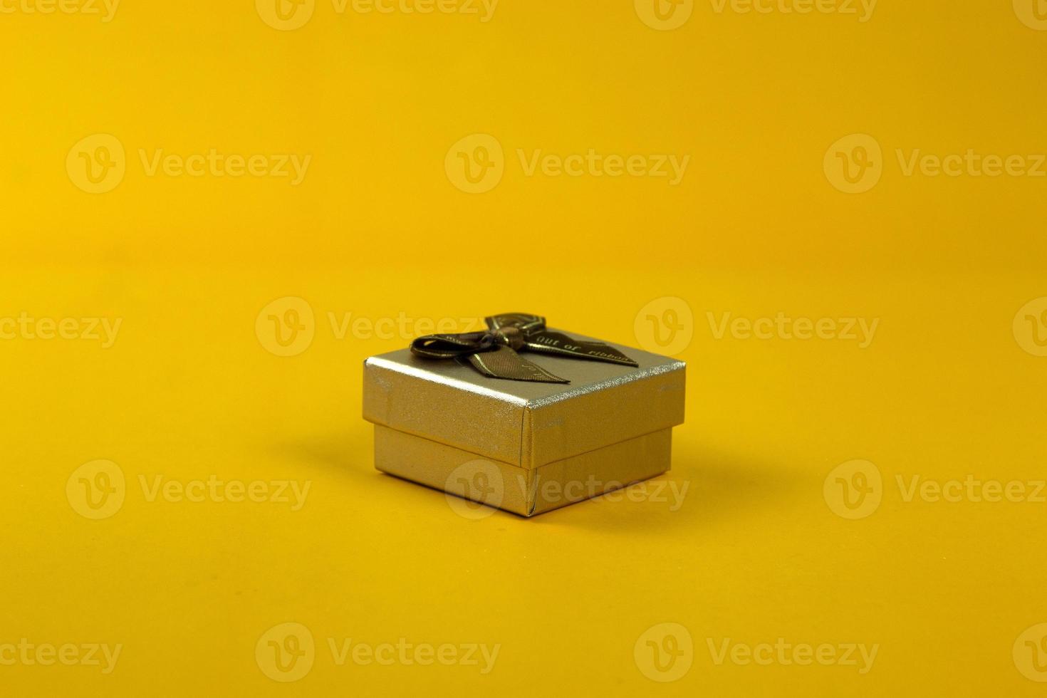 Gift box used in sale off promo posters and print ads design, and realistic close up position on yellow background. photo