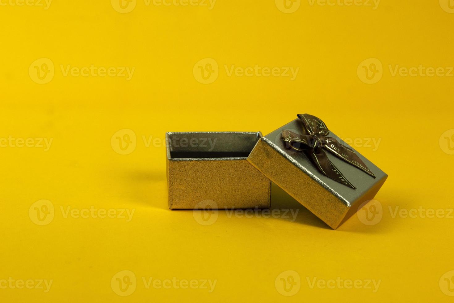Golden Gift box is opened on yellow background and spacing for text description concepts design. photo