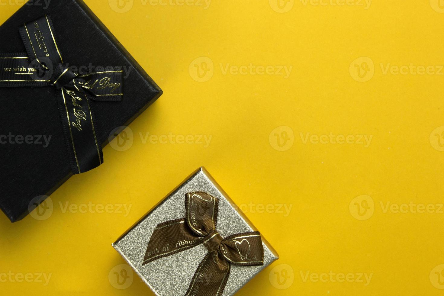New Year and Christmas gift boxes concept for giving on special Occasion, Realistic  gifts boxes on yellow background top view anglr, usage of decorative festive object. Holiday banner. photo