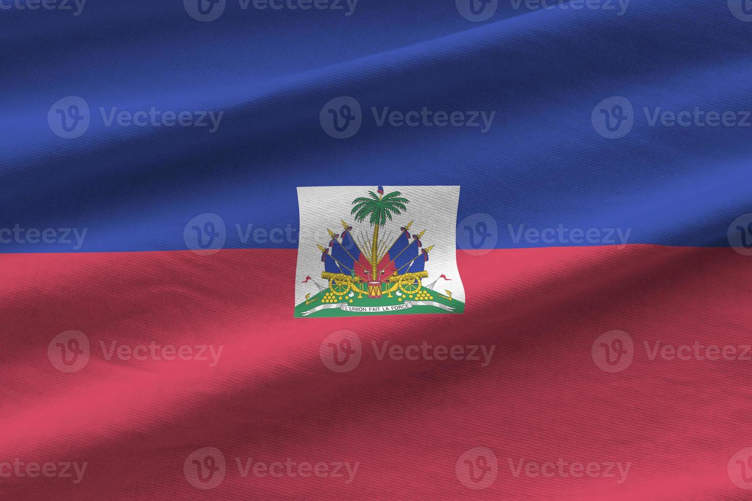 Haiti flag with big folds waving close up under the studio light indoors. The official symbols and colors in banner photo