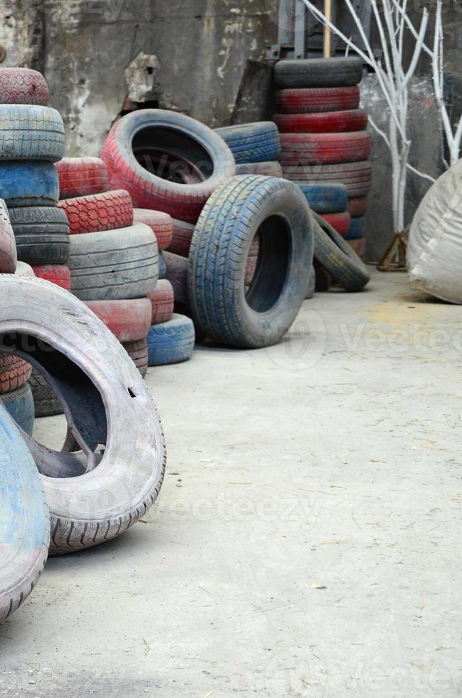 A picture of many old used tires left on a waste dump photo