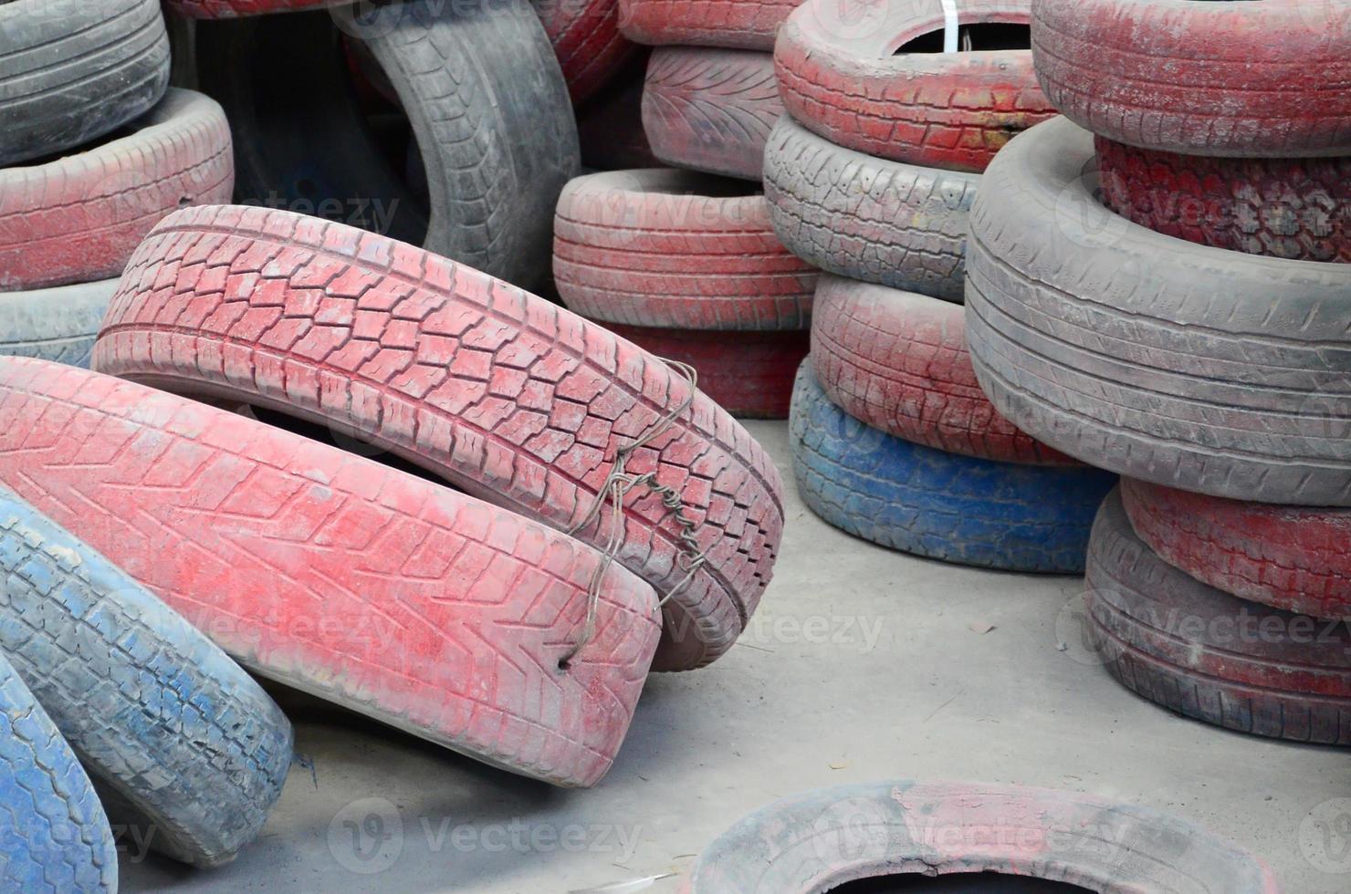 A picture of many old used tires left on a waste dump photo