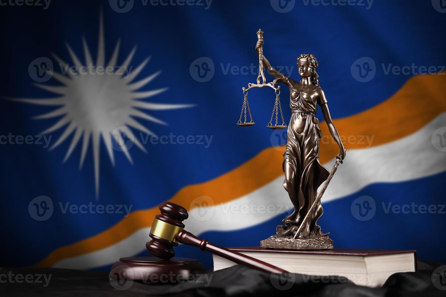 Marshall Islands flag with statue of lady justice, constitution and judge hammer on black drapery. Concept of judgement and guilt photo