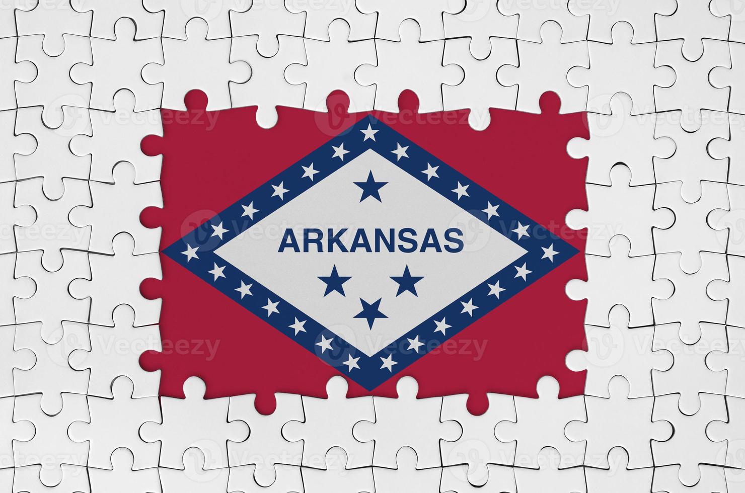 Arkansas US state flag in frame of white puzzle pieces with missing central part photo