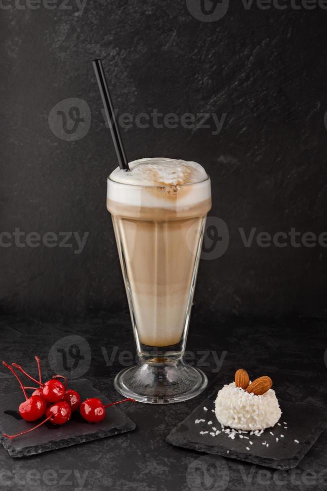 close-up of a barista making coffee with syrup and cream foam in cafe photo