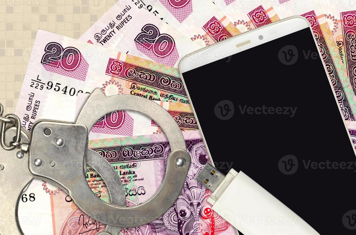 20 Sri Lankan rupees bills and smartphone with police handcuffs. Concept of hackers phishing attacks, illegal scam or malware soft distribution photo