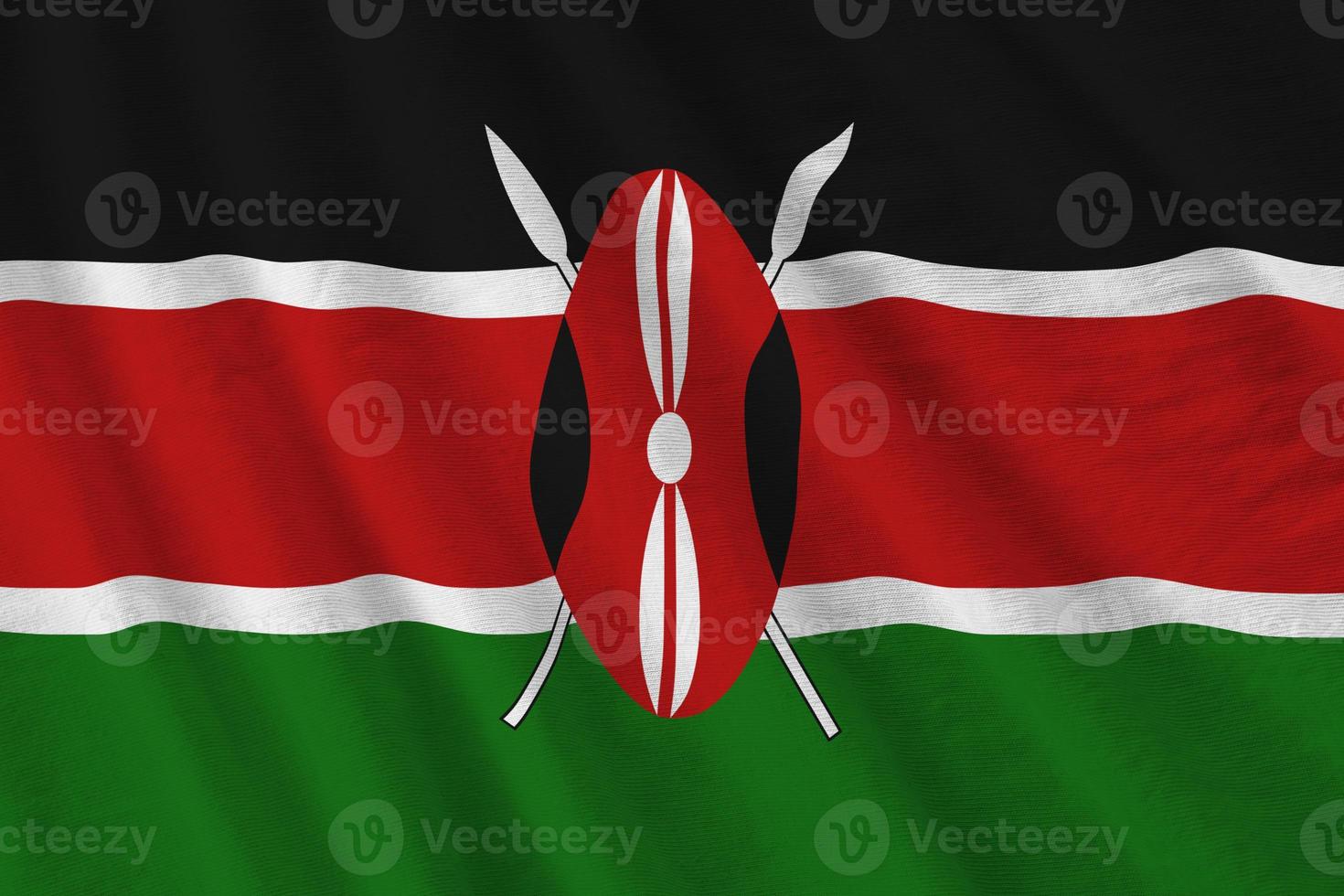 Kenya flag with big folds waving close up under the studio light indoors. The official symbols and colors in banner photo