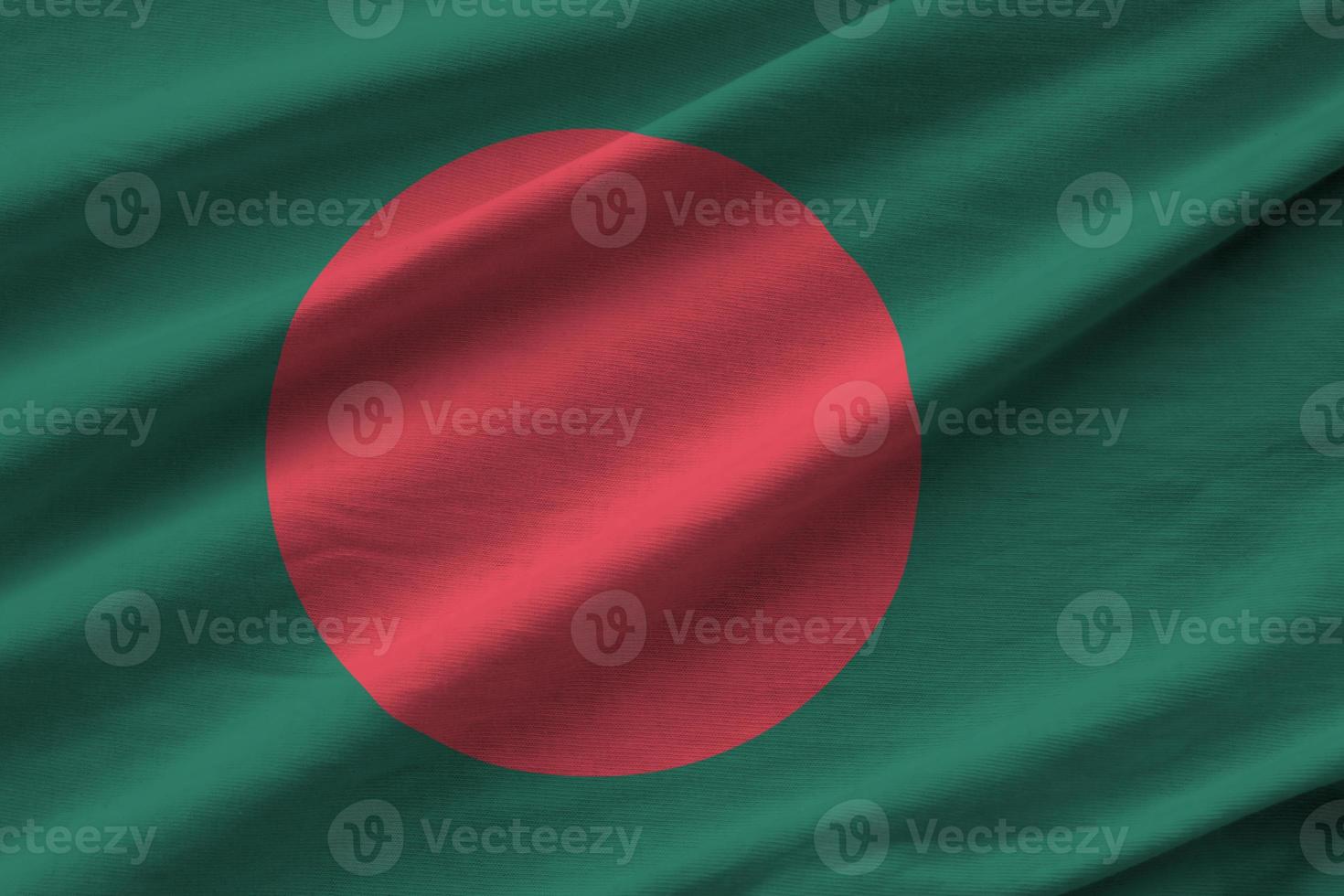 Bangladesh flag with big folds waving close up under the studio light indoors. The official symbols and colors in banner photo