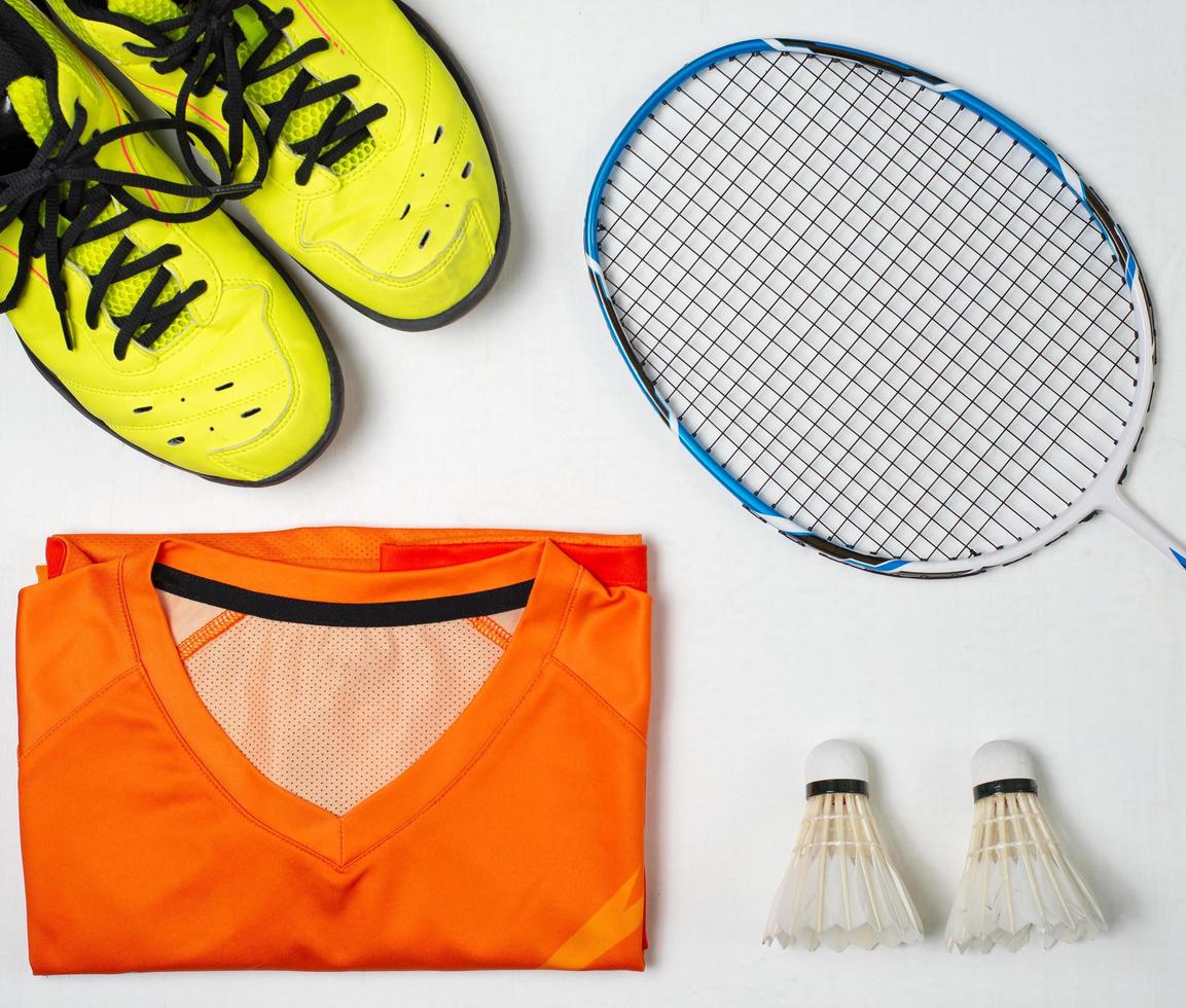 Badminton competition equipment, Badminton racket, Badminton ball and shoes on white wood background photo