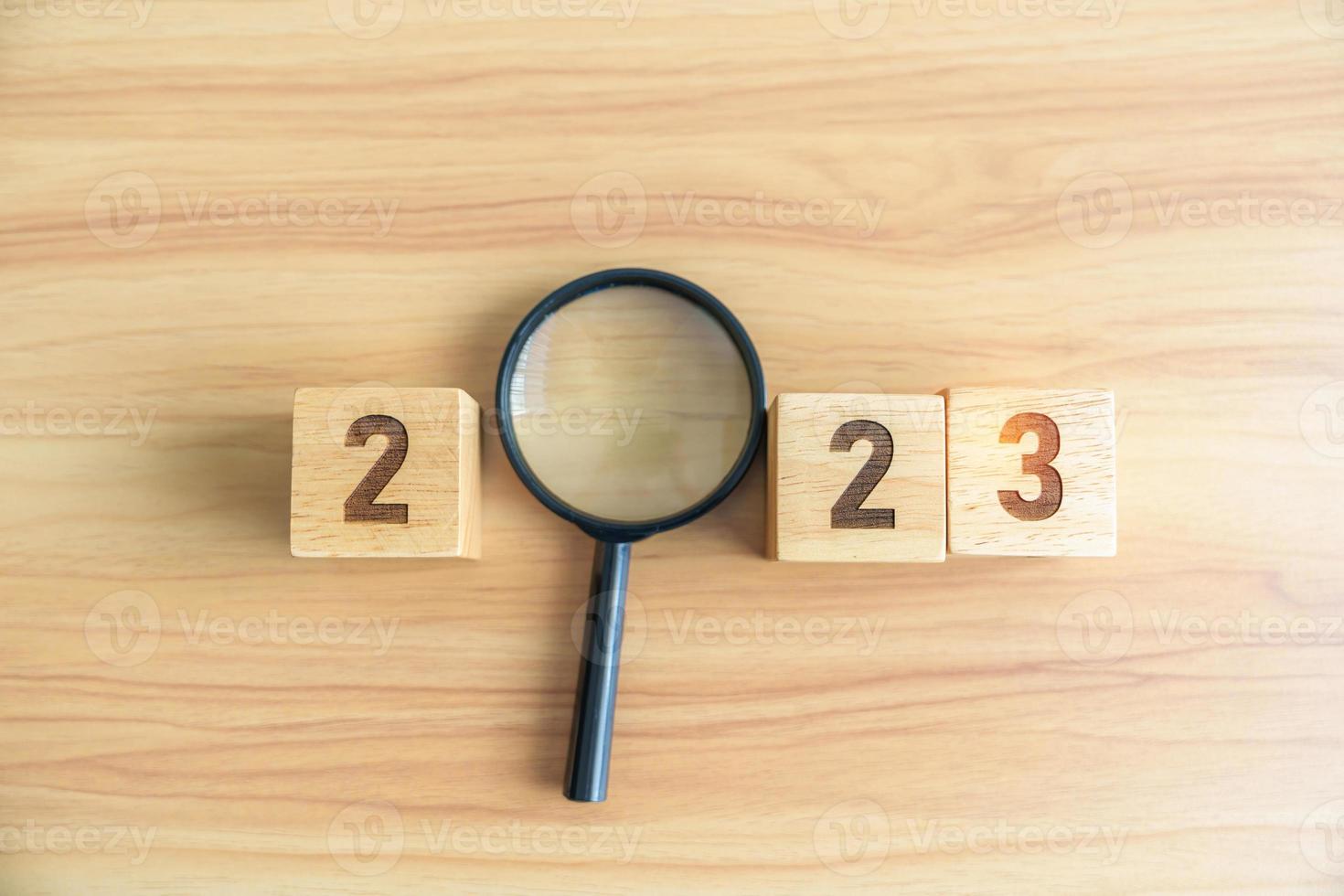 2023 block with magnifying glass. SEO, Search Engine Optimization, hiring , Advertising, Idea, Strategy, marketing, Keyword, Content and New Year start concepts photo