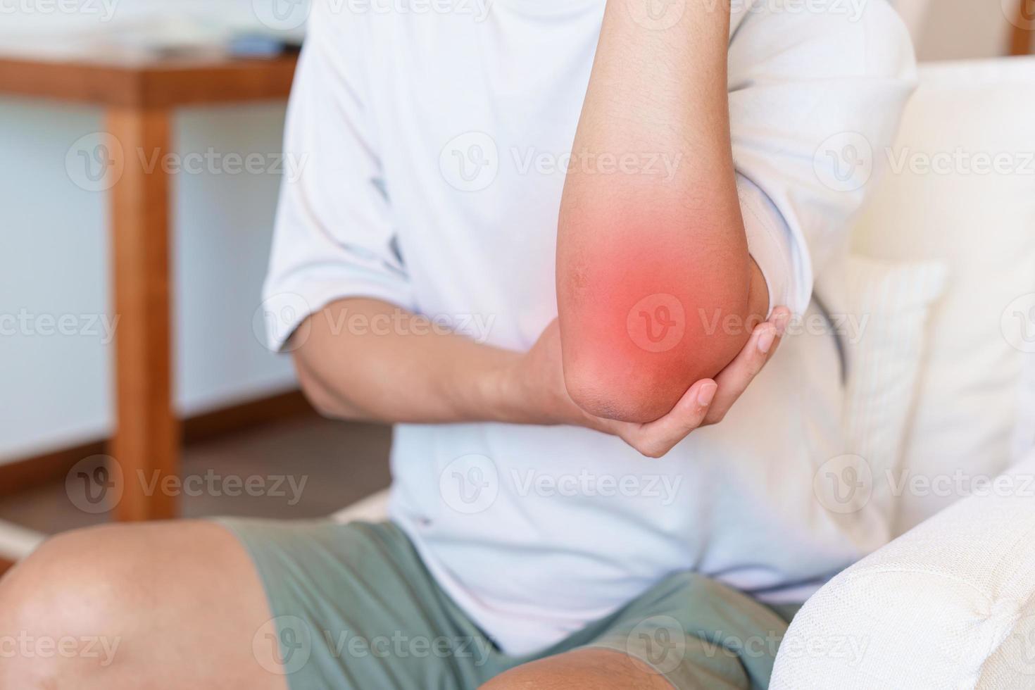 Man having elbow ache and muscle pain due to lateral epicondylitis or tennis elbow. injuries and medical concept photo