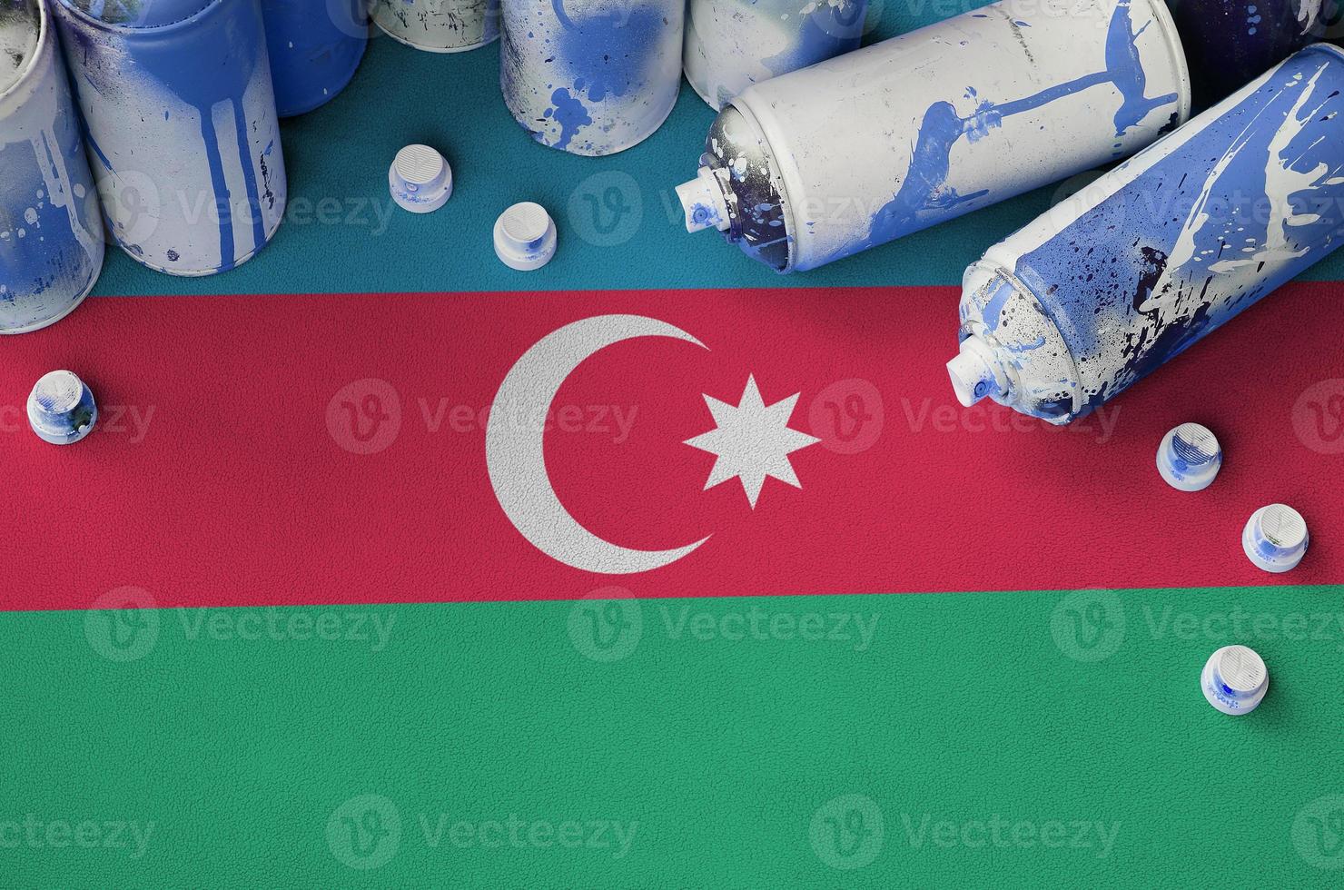Azerbaijan flag and few used aerosol spray cans for graffiti painting. Street art culture concept photo