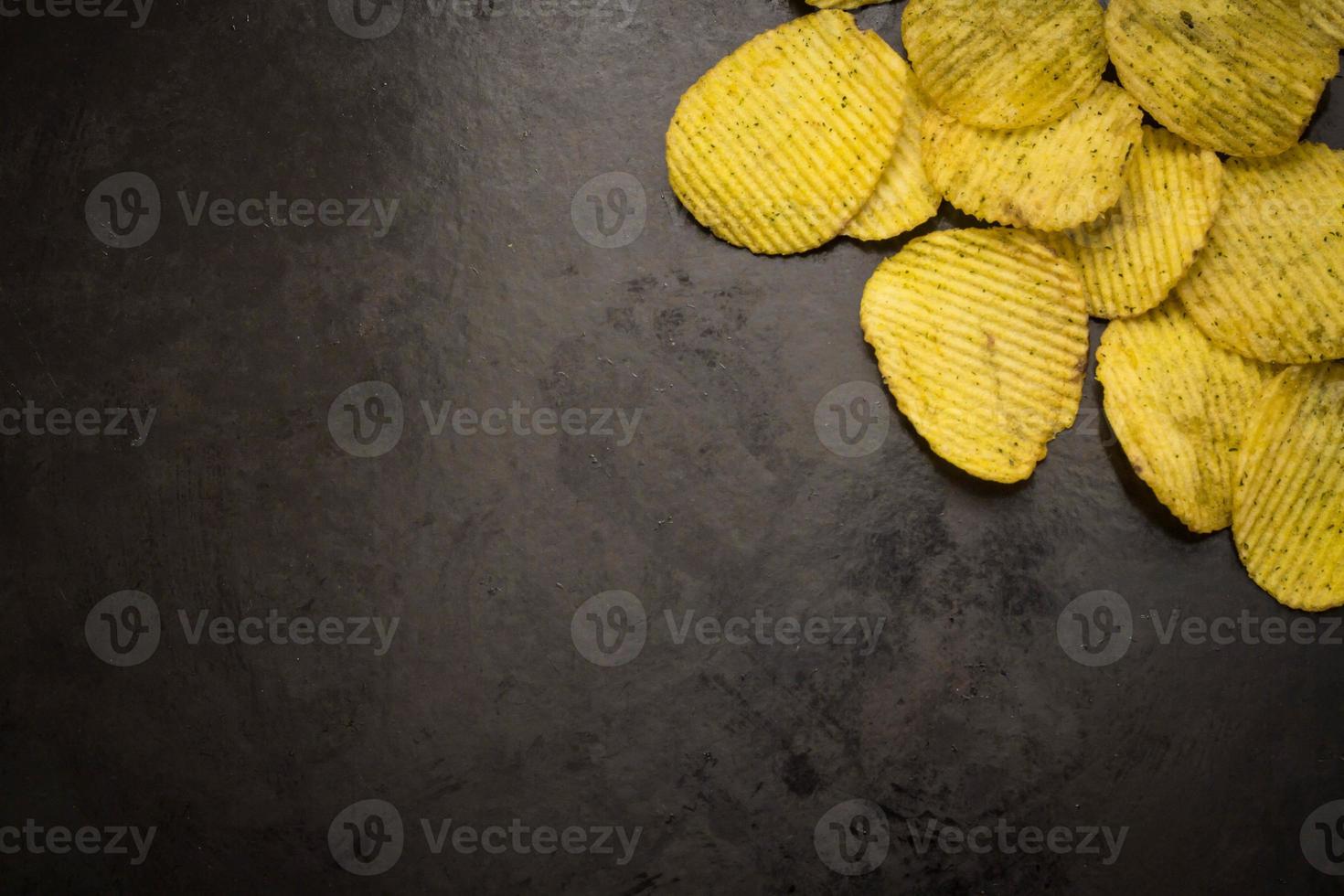 potato chips on a dark background photo