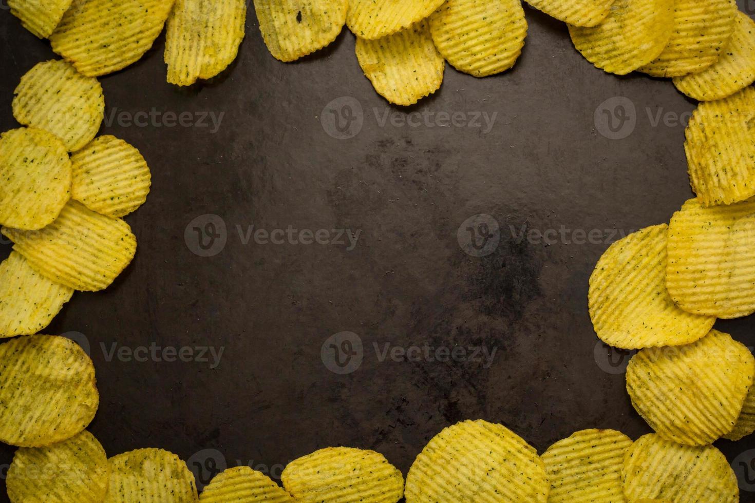 potato chips on a dark background photo