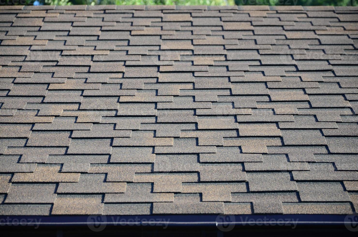 Modern roofing and decoration of chimneys. Flexible bitumen or slate shingles photo