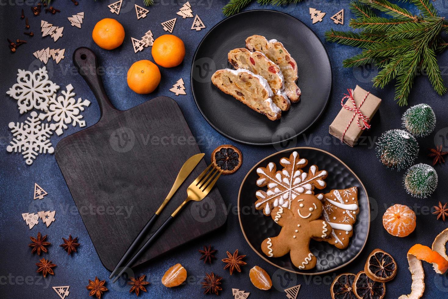 Delicious festive New Year's pie with candied fruits, marzipan and nuts on a dark concrete background photo