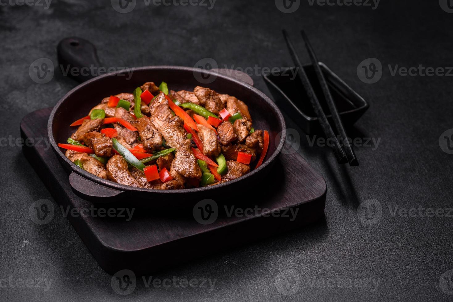 Delicious Asian teriyaki meat with red and green bell peppers photo